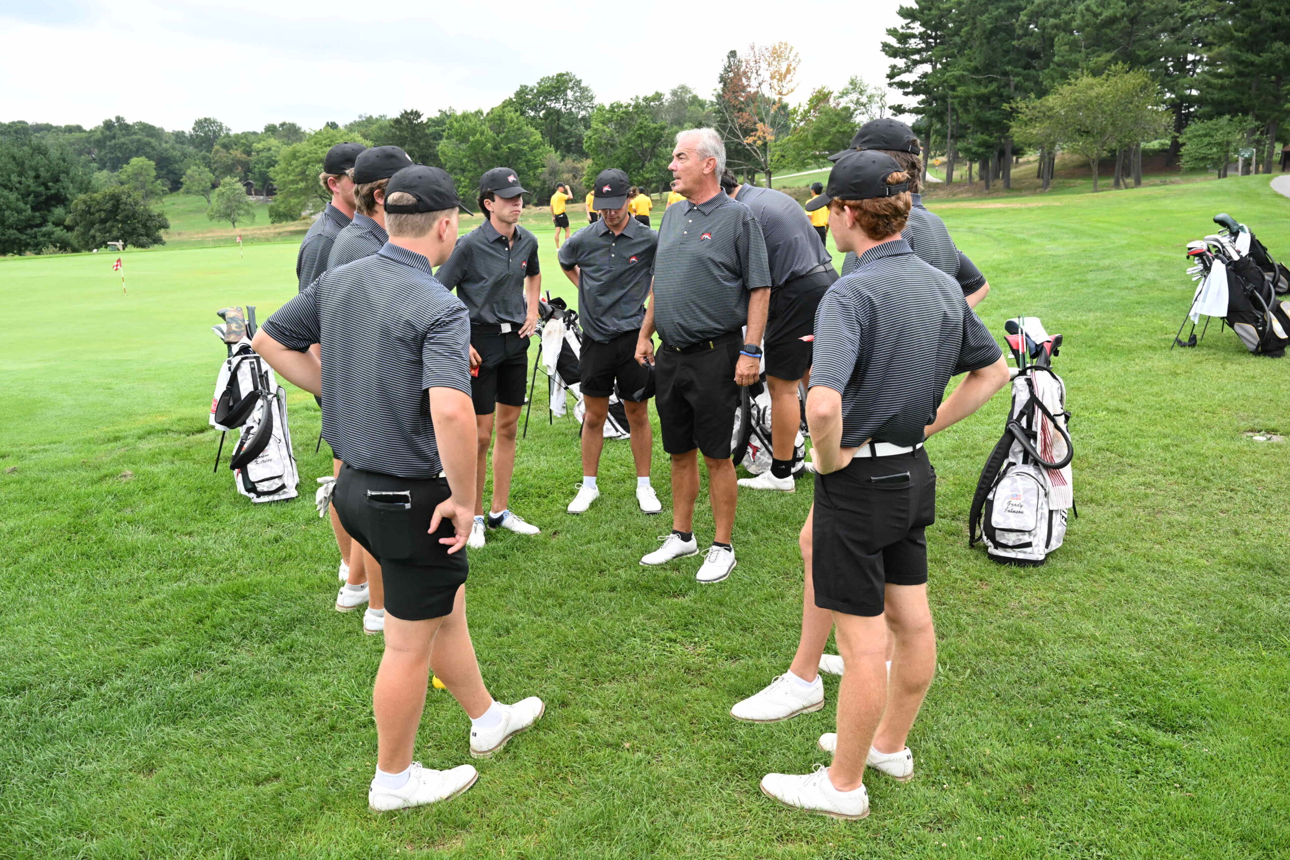 Boy golfers with coach