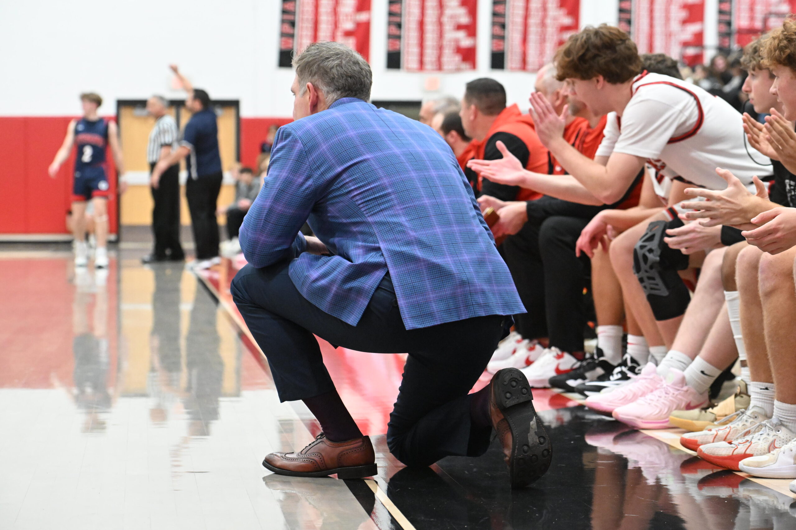 Basketball coach watching game from bench